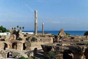 View of the historical landmark The Baths of Antoninus in Carthage , Tunisia. Unesco World Heritage Site. Archaeological Site of Carthage. Place of historic interest. Ancient ruins. photo