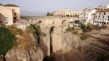 Aerial drone view of the New Bridge in Ronda. White villages in the province of Malaga, Andalusia, Spain. Beautiful village on the cliff of the mountain. Touristic destination. Holidays. photo