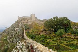 View of Marvao Castle on a foggy day. Historic Villages of Portugal. Old town inside of a fortified wall on the cliff of a mountain. Rural tourism. Holidays. Best destinations in the world. photo