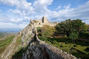 View of Marvao Castle during a sunny day with clouds. Historic Villages of Portugal. Old town inside of a fortified wall on the cliff of a mountain. Rural tourism. Holidays. Best destinations. photo