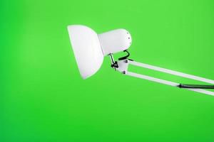 Office table lamp on green background with space for text and idea concept photo