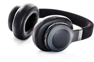 Wireless black headphones on white, isolate. On-ear headphones for playing games and listening to music tracks. Close-up photo