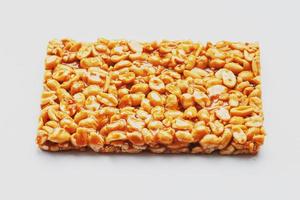 Healthy snacks. Fitness diet food. Kozinaki fritters made from roasted peanuts, energy bars. White background top view. Isolate, Copy Space photo