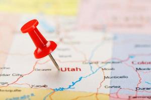 Red clerical needle on a map of USA, Utah and the capital Salt Lake City. Closeup Map Utah with Red Tack photo