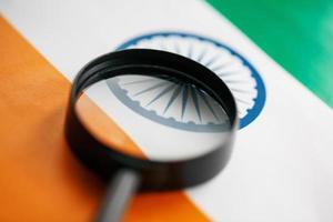 Learning Indian language concept. Young woman standing with the India flag in the background. Teacher holding books, orange blank book cover photo