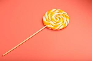 Colorful round Lollipop on pink background. Minimal concept with copy space. photo