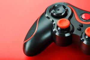 Game controller controller on red background. Device to control and control the game. close up photo