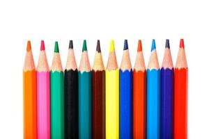 Colored pencils in a row on a white background, free space for text. photo