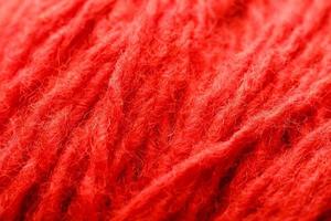 Wool yarn close-up colorful red thread for needlework in macro. photo