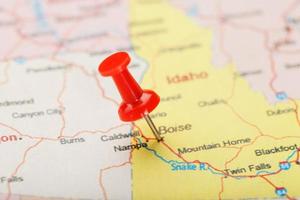Red clerical needle on a map of USA, Idaho and the capital Boise. Closeup Map Idaho with Red Tack photo
