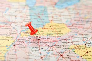 Red clerical needle on a map of USA, South Tennessee and the capital Nashville. Close up map of South Tennessee with red tack photo