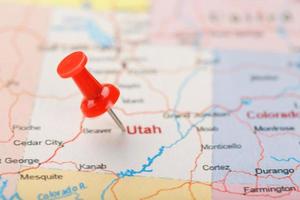 Red clerical needle on a map of USA, Utah and the capital Salt Lake City. Closeup Map Utah with Red Tack photo