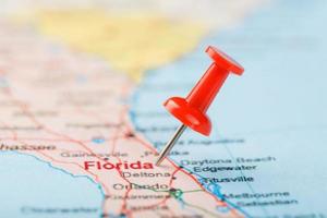 Red clerical needle on a map of USA, South Florida and the capital Tallahassee. Close up map of South Florida with red tack photo