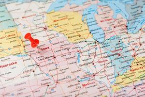 Red clerical needle on a map of USA, Iowa and the capital Des Moines. Close up map of Iowa with red tack photo