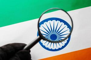 Learning Indian language concept. Young woman standing with the India flag in the background. Teacher holding books, orange blank book cover photo