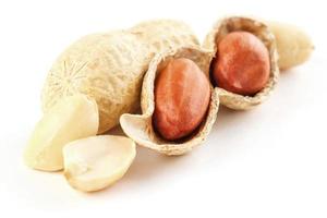 Peanuts closeup in shell and peeled on a white background photo