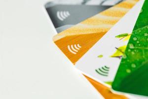 Credit cards with contactless payment. Pile of credit cards on white isolated background photo