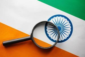 Learning Indian language concept. Young woman standing with the India flag in the background. Teacher holding books, orange blank book cover photo