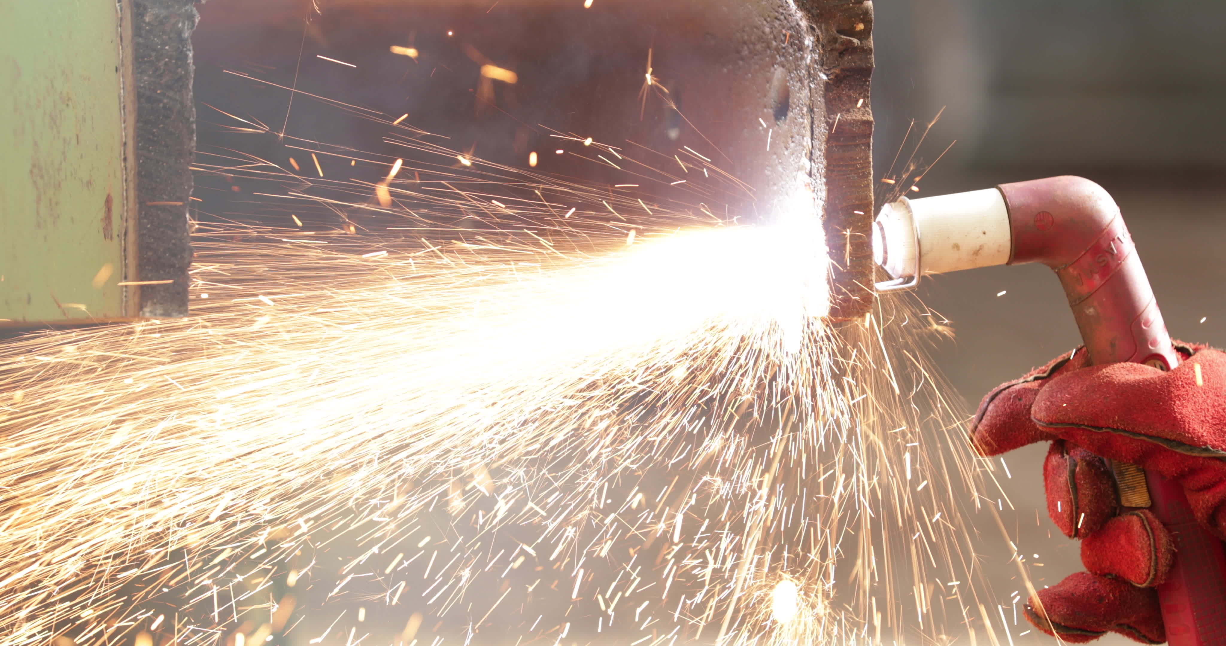 Sparks From A Blow Torch Cutting Rusty Steel In Slow Motion close up