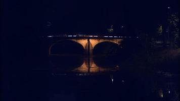 The stunning view of a small bridge in Leiria, Portugal with lights on the sides of the arch over the Rio Lis River - Wide shot video