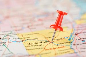 Red clerical needle on a map of USA, Arkansas and the capital Little Rock. Close up map of Arkansas with red tack photo