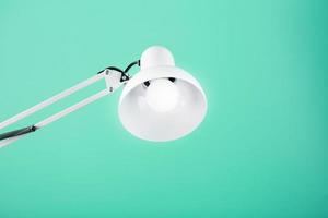Classic table lamp on green background with space for text and idea concept photo