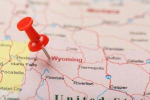 Red clerical needle on a map of USA, Wyoming and the capital Cheyenne. Close up map of wyoming with red tack photo