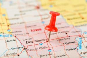 Red clerical needle on a map of USA, Iowa and the capital Des Moines. Close up map of Iowa with red tack photo