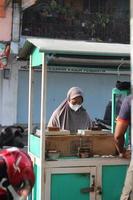magelang,indonesia,2022-pancong cake atau kue gandos  seller on the roadside photo