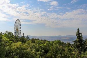 Ferris wheel in an amusement park in  green region photo