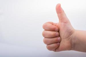 kid giving  thumb up as a symbol and like icon photo