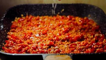 Fried eggs in Georgian cuisine, chirbuli. Eggs with tomatoes steaming in the pan video