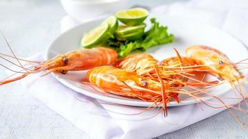 Seafood shrimp menu in a plate on a white table photo