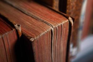 Very old books sitting on the shelves in the library. Books as a symbol of knowledge. photo