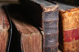 Very old books sitting on the shelves in the library. Books as a symbol of knowledge. photo