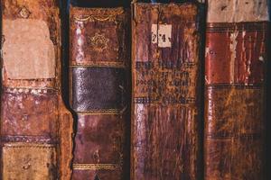 Very old books sitting on the shelves in the library. Books as a symbol of knowledge. photo