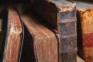 Very old books sitting on the shelves in the library. Books as a symbol of knowledge. photo