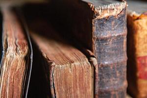 Very old books sitting on the shelves in the library. Books as a symbol of knowledge. photo