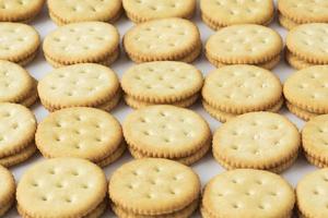 Rows of crackers on white background photo