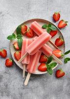 Strawberry ice cream popsicles photo