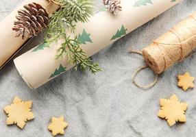 Wrapping paper with a pine branch and Christmas cookies on a textile background photo