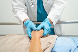 Holding hands Asian senior or elderly old lady woman patient with love, care, encourage and empathy at nursing hospital ward, healthy strong medical concept photo