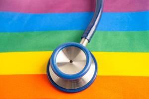 stethoscope on rainbow flag background, symbol of LGBT pride month  celebrate annual in June social, symbol of gay, lesbian, bisexual, transgender, human rights and peace. photo