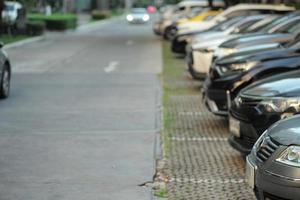 Selective focus on the car in the parking lots with blurred row of vehicle in background. Picture was blurred in purpose photo