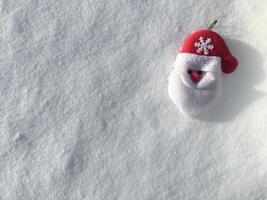 Toy of Santa Claus on the snow. Place for text. Your text here
