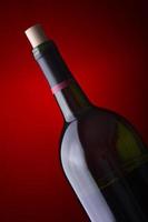 wine bottle on a red background photo