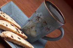 a cup of coffee with biscotti photo