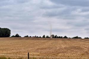 dust devil over the field on a hot summer day in Germany - weather phenomenon photo