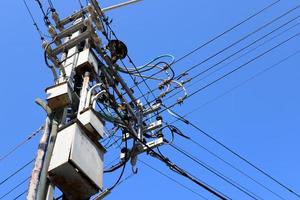 Wires on a pole carrying high voltage electric current. photo