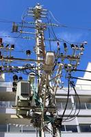 Wires on a pole carrying high voltage electric current. photo